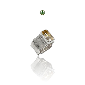A citrine gemstone ring with white rhodium plating on a silver band, displayed against a white background.