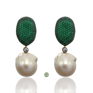 Pair of earrings with green gemstone drops and pearl-like bases on a white background
