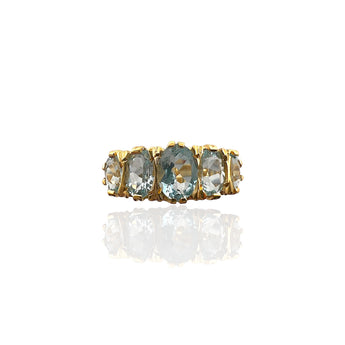 Front view of the Art Deco inspired ring with five oval pale blue topaz stones