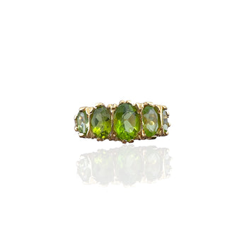Front view of the Art Deco inspired ring with five oval green peridots