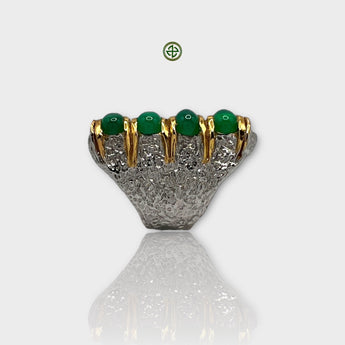 A silver ring with a gold vermeil band featuring a green onyx gemstone and white rhodium plating.