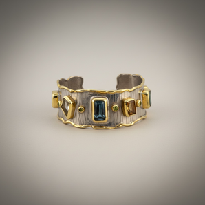 Luxury 18K gold vermeil cuff bracelet set on 925 sterling silver featuring kyanite, lemon quartz, London blue topaz, green amethyst and orange tourmaline. Handmade statement gemstone cuff.