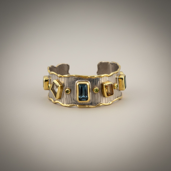 Luxury 18K gold vermeil cuff bracelet set on 925 sterling silver featuring kyanite, lemon quartz, London blue topaz, green amethyst and orange tourmaline. Handmade statement gemstone cuff.