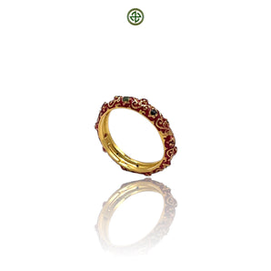 A micro eternity ring with alternating ruby, emerald, and sapphire stones set in red enamel, with a gold vermeil finish on a silver band.