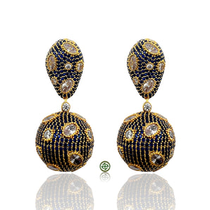 Pair of gold and blue earrings on a white background