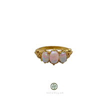 A Smilla Opal ring with a central opal stone surrounded by smaller opal inlays, set in a gold vermeil on silver base.