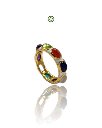 A multicolored gemstone ring with a gold band and white enamel detailing, featuring a variety of gemstones including amethyst, ruby, and sapphire.