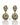 Pair of gold earrings with green gemstones on a white background