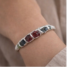 Sterling silver bracelet with rough peridot and garnet stones. Adjustable 16–17 cm (6.3–6.7 in), hammered finish, perfect for stacking and everyday wear.