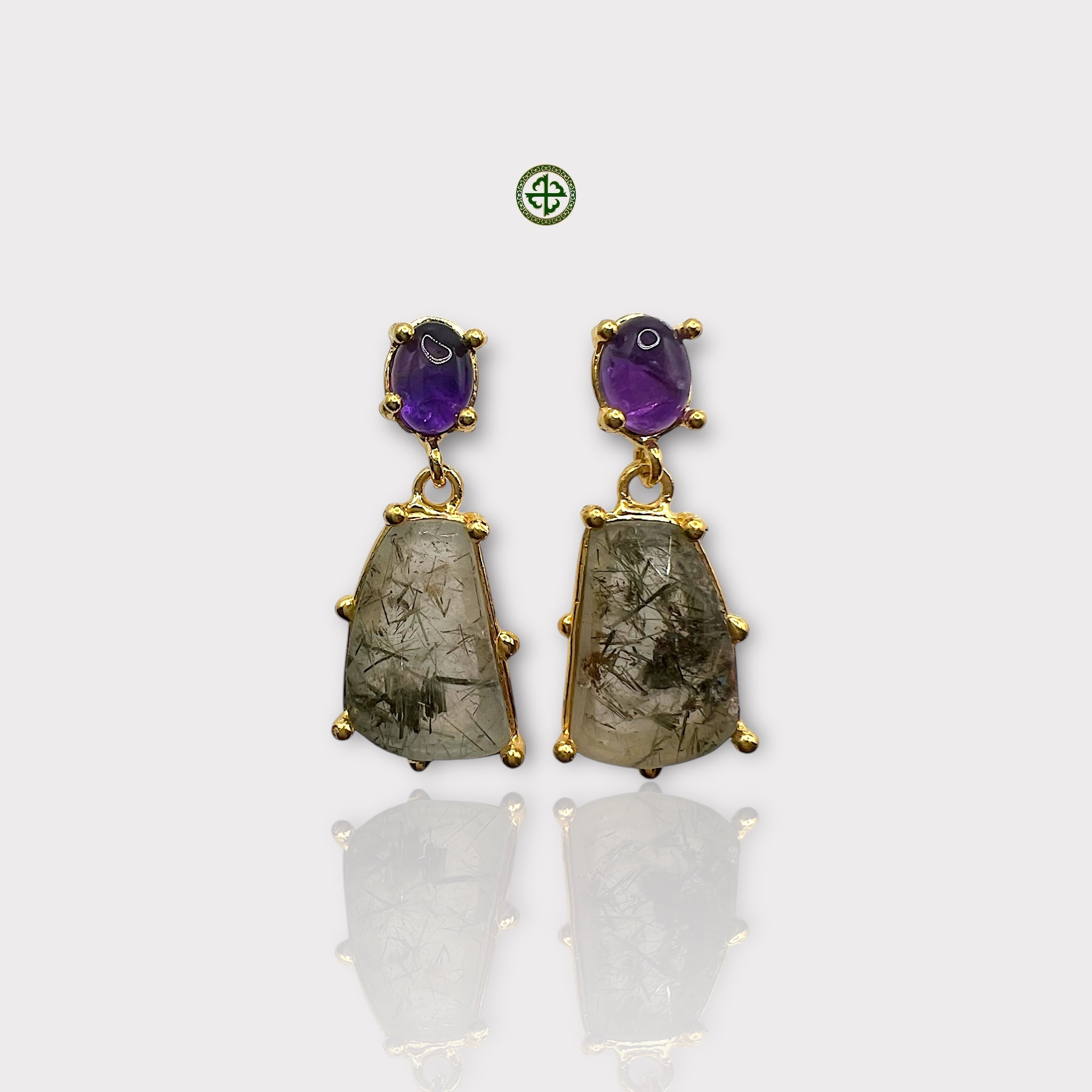 A pair of gold vermeil earrings featuring amethyst and rutile quartz stones.