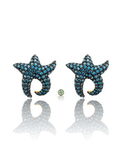Starfish-shaped earrings with blue gemstones on a white background