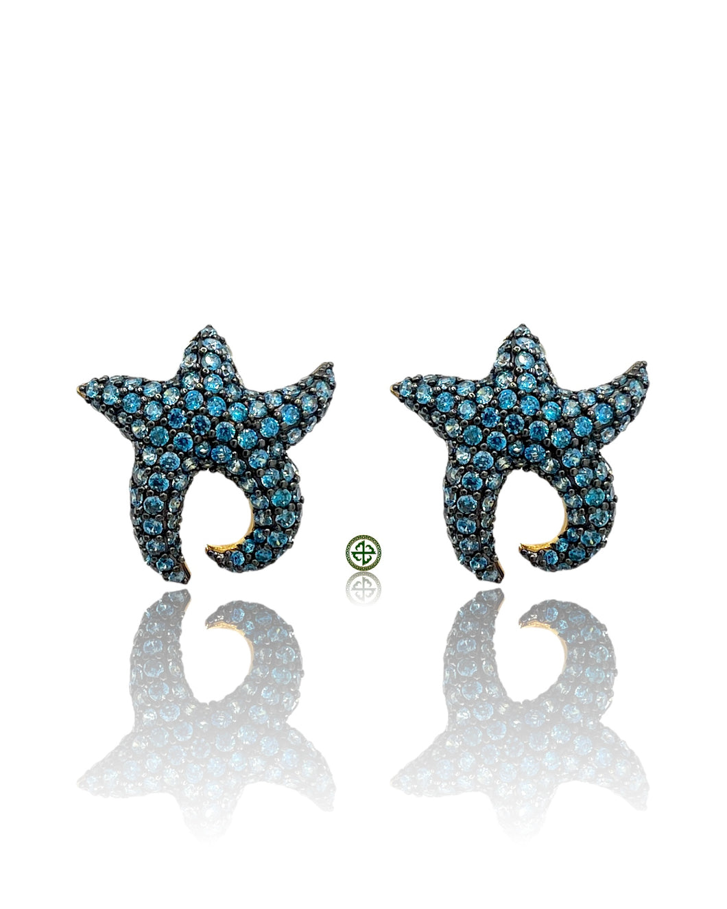 Starfish-shaped earrings with blue gemstones on a white background