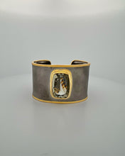 Luxury green amethyst cuff bangle crafted in black rhodium plated 925 sterling silver with thick 18K gold vermeil bezel. Elegant wide statement bracelet adjustable for 16–17 cm wrists.
