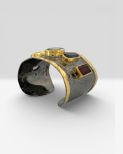 Luxury wide cuff bangle crafted from black rhodium plated 925 sterling silver with thick 18K gold vermeil. Featuring Green Amethyst, Kyanite, Tourmaline, Blue Topaz and Amethyst gemstones. Adjustable statement bracelet for 16–18 cm wrists.
