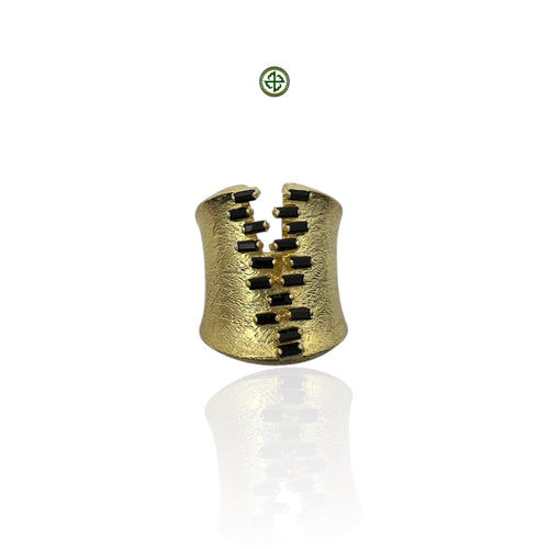 A gold vermeil ring with black spinel stones set in an open band design, with a textured finish.
