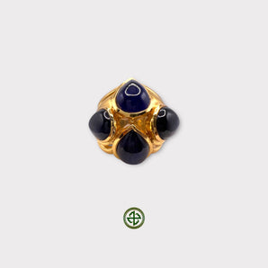 A gold-colored ring featuring a central blue agate stone with four smaller stones around it.