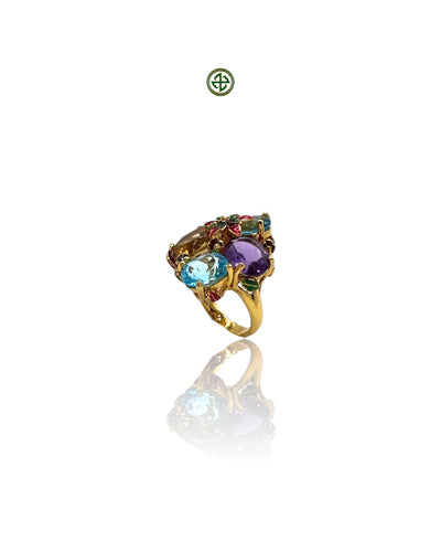 A colorful ring with blue topaz, amethyst, and citrine gemstones, set in a gold vermeil on silver band.