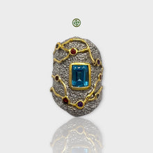 A detailed image of a Blue Topaz natural stone ring with gold and silver plating, featuring multiple colored gemstones.