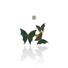 A gold vermeil on silver butterfly ring adorned with green zirconia stones