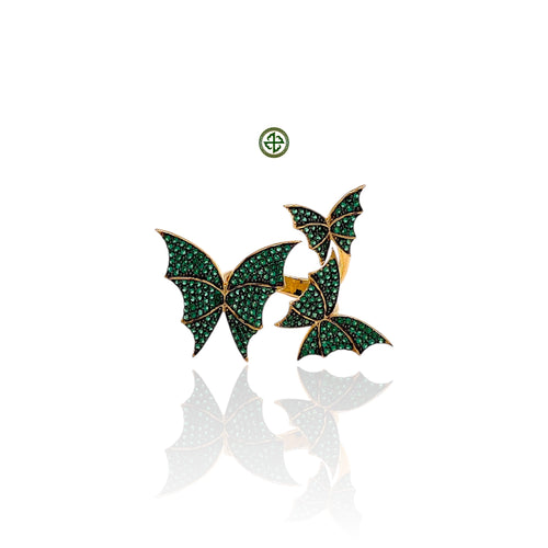 A gold vermeil on silver butterfly ring adorned with green zirconia stones