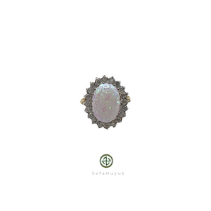 An opal and zirconia ring with a silver setting and 18ct yellow gold plating, featuring a cluster of zirconias around the opal.
