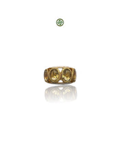A gold-colored ring with four citrine stones arranged in a line, set against a white background.