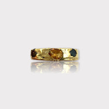 A gold vermeil band ring featuring a raw and natural uncut gemstone, with colors yellow, green, and blue, set in a textured setting.
