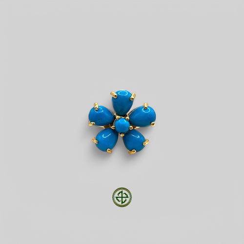 A gold vermeil ring with a turquoise flower-like design on a white background.