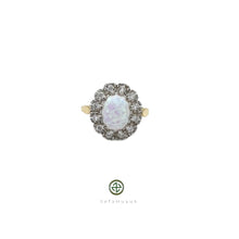 An 18ct gold vermeil on silver ring with a central opal stone and surrounding zirconia embellishments.