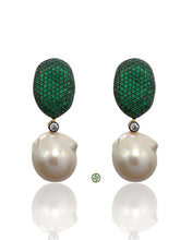 Pair of earrings with green gemstone drops and pearl-like bases on a white background