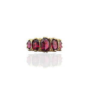 Front view of the Art Deco inspired ring with five oval raspberry rhodolite garnets