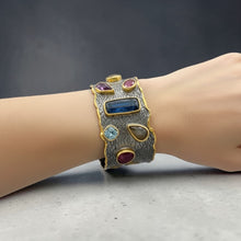 Luxury black rhodium and 18K gold plated cuff bracelet on 925 sterling silver featuring citrine, amethyst, ruby, kyanite, rutilated quartz, blue topaz and orange tourmaline.