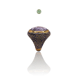 An oval-shaped genuine amethyst gemstone set in a gold vermeil band with blue enamel detailing.