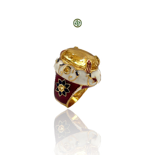 A gold vermeil ring with a large citrine stone and red and white enamel accents, featuring a floral design.
