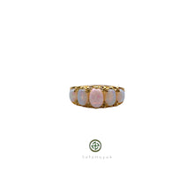 An opal ring with gold vermeil plating on a silver base, featuring a central opal stone surrounded by smaller clear crystals set in a gold-colored band.