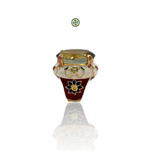 An elegant Green Amethyst Ring with gold vermeil plating, featuring a large oval green amethyst center stone, surrounded by smaller stones set in a red, white, and blue enamel design on a silver band.