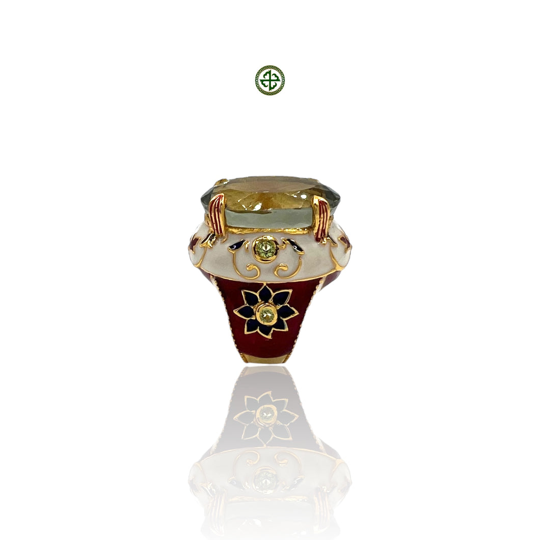 An elegant Green Amethyst Ring with gold vermeil plating, featuring a large oval green amethyst center stone, surrounded by smaller stones set in a red, white, and blue enamel design on a silver band.