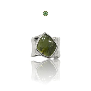 A green tourmaline gemstone set in a sterling silver ring with a white rhodium finish.