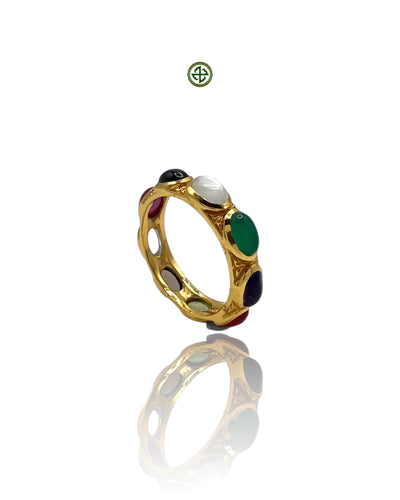 A gold vermeil on sterling silver eternity ring with multiple gemstones set in a polished band.