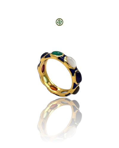 A navy blue enamel eternity ring with gold vermeil and multiple gemstones set within the band.