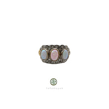 A women's opal and white zircon ring with gold vermeil plating on a silver base, featuring a pear-shaped opal in the center surrounded by white zircons along the band.