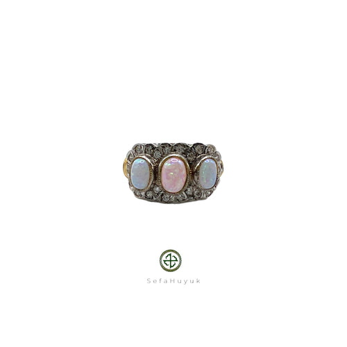 A women's opal and white zircon ring with gold vermeil plating on a silver base, featuring a pear-shaped opal in the center surrounded by white zircons along the band.