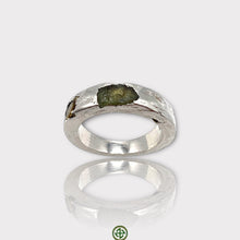 A silver ring featuring a raw peridot and yellow tourmaline gemstone, with a white rhodium plating.