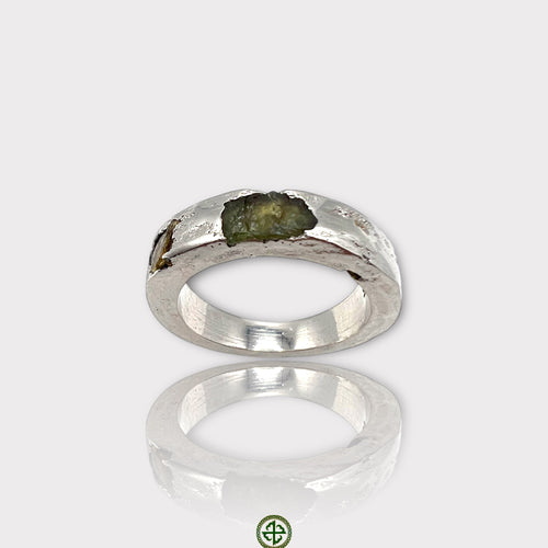 A silver ring featuring a raw peridot and yellow tourmaline gemstone, with a white rhodium plating.
