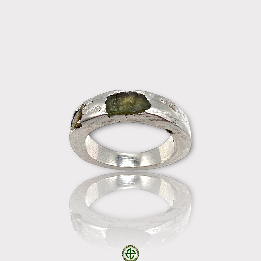 A silver ring featuring a raw peridot and yellow tourmaline gemstone, with a white rhodium plating.