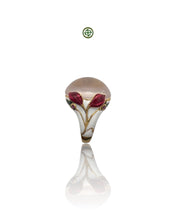 A rose quartz center stone ring with red and white enamel floral patterns and small ruby side stones, gold vermeil plating, displayed against a white background.