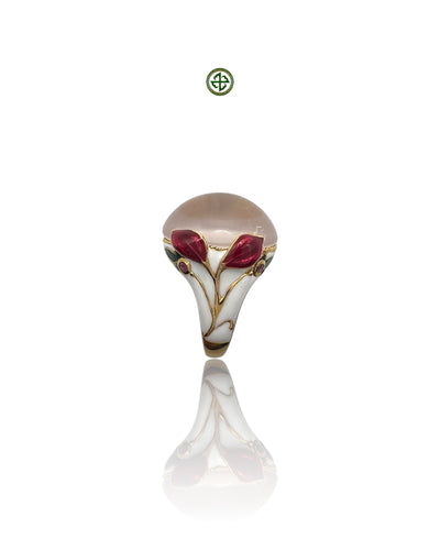 A rose quartz center stone ring with red and white enamel floral patterns and small ruby side stones, gold vermeil plating, displayed against a white background.