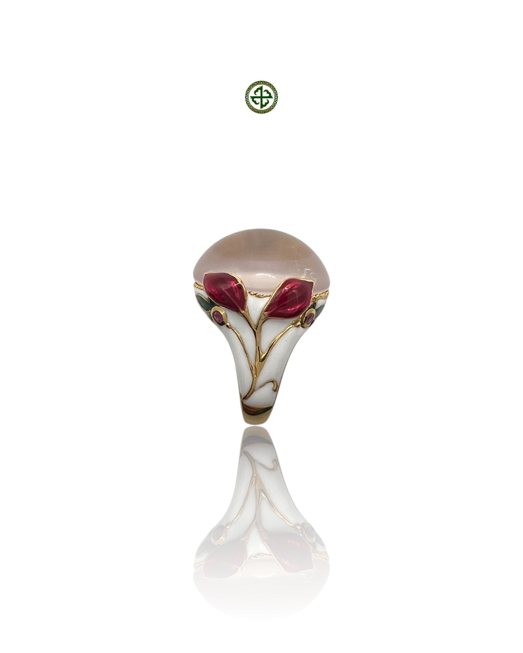A rose quartz center stone ring with red and white enamel floral patterns and small ruby side stones, gold vermeil plating, displayed against a white background.