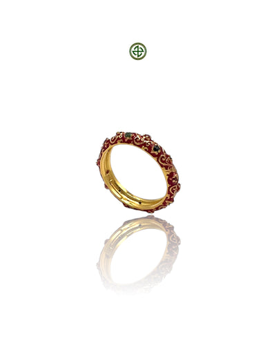 A micro eternity ring with alternating ruby, emerald, and sapphire stones set in red enamel, with a gold vermeil finish on a silver band.