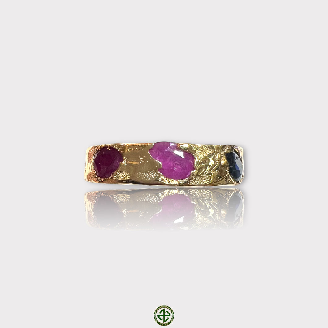 An opal eternity ring with a textured band featuring irregular shaped gemstones in gold vermeil setting.